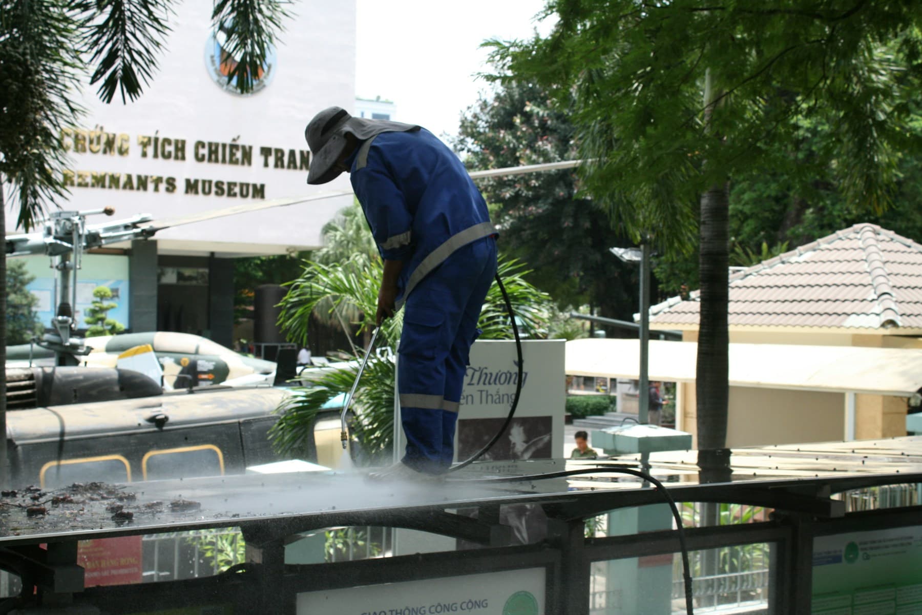Worker pressure washing an outdoor surface