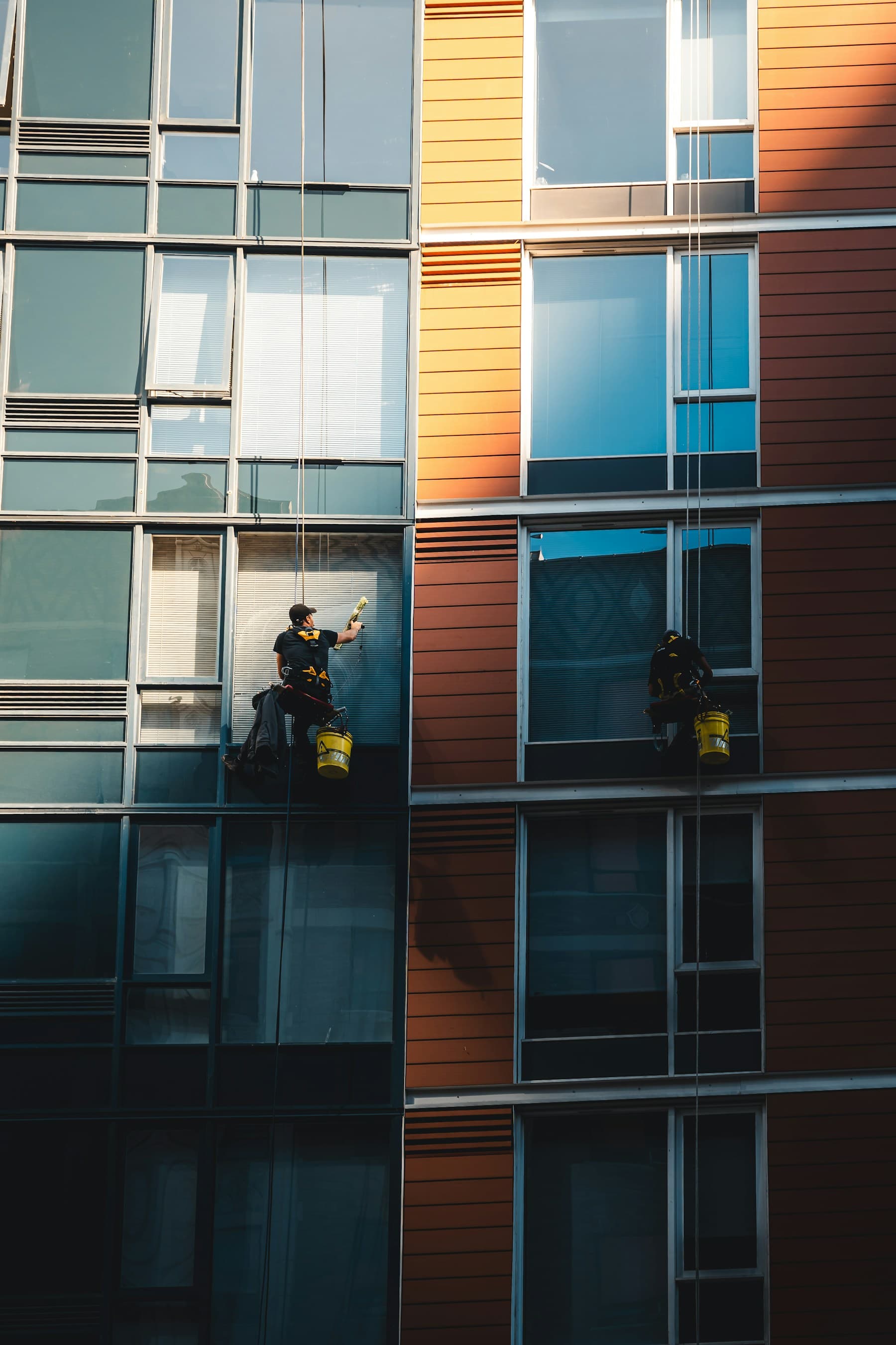 Window washer cleaning exterior glass from an elevated platform